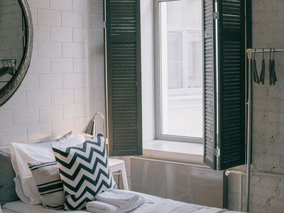 Minimalist room with large window and soft light.