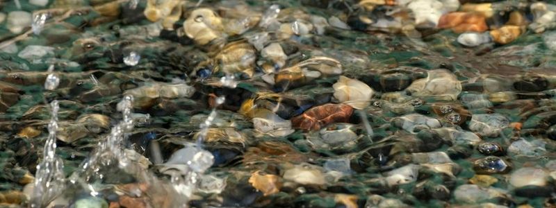 Smooth stones and water surface representing peace.